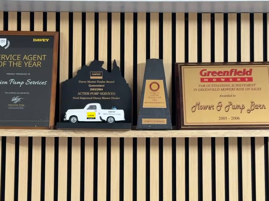 Four awards on the shop wall, including a Davey Service Agent of the Year certificate and a Davey Master Dealer award for Queensland.